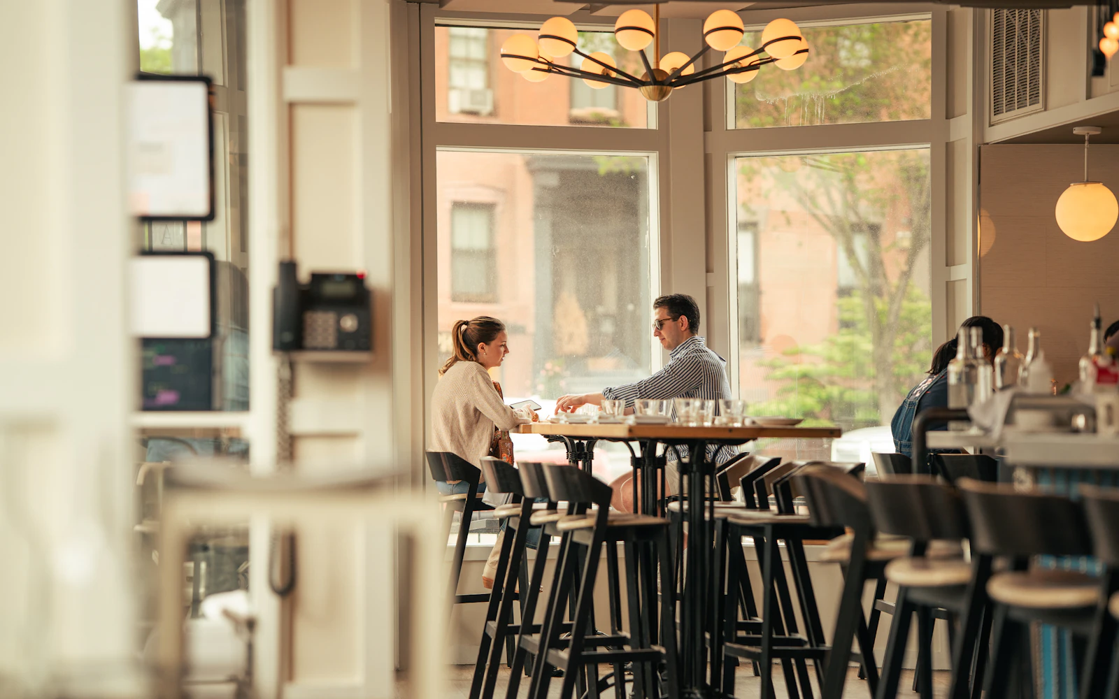 Two adults having a relaxed conversation in a neighborhood café