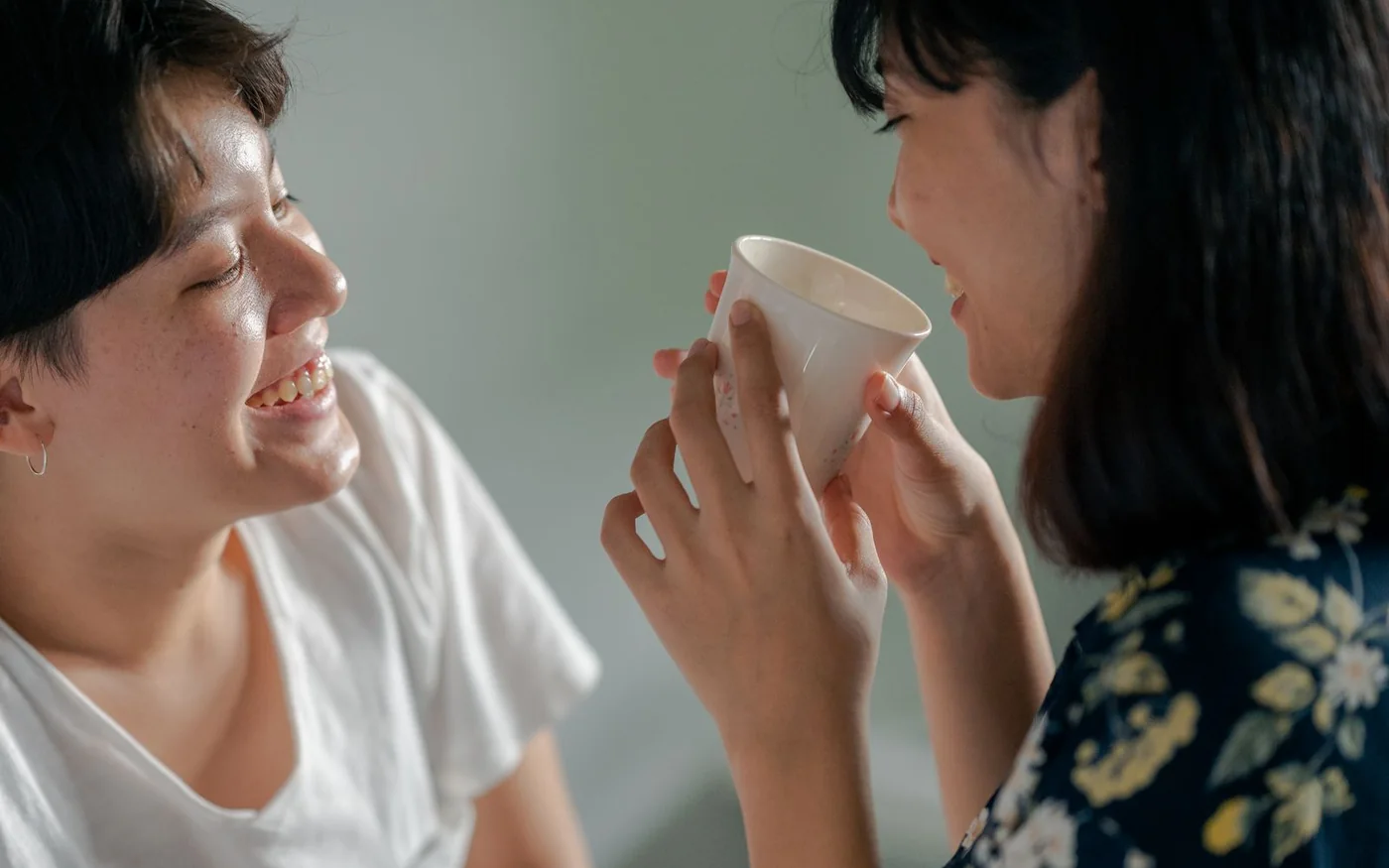 Two adult women sharing a relaxed conversation over coffee